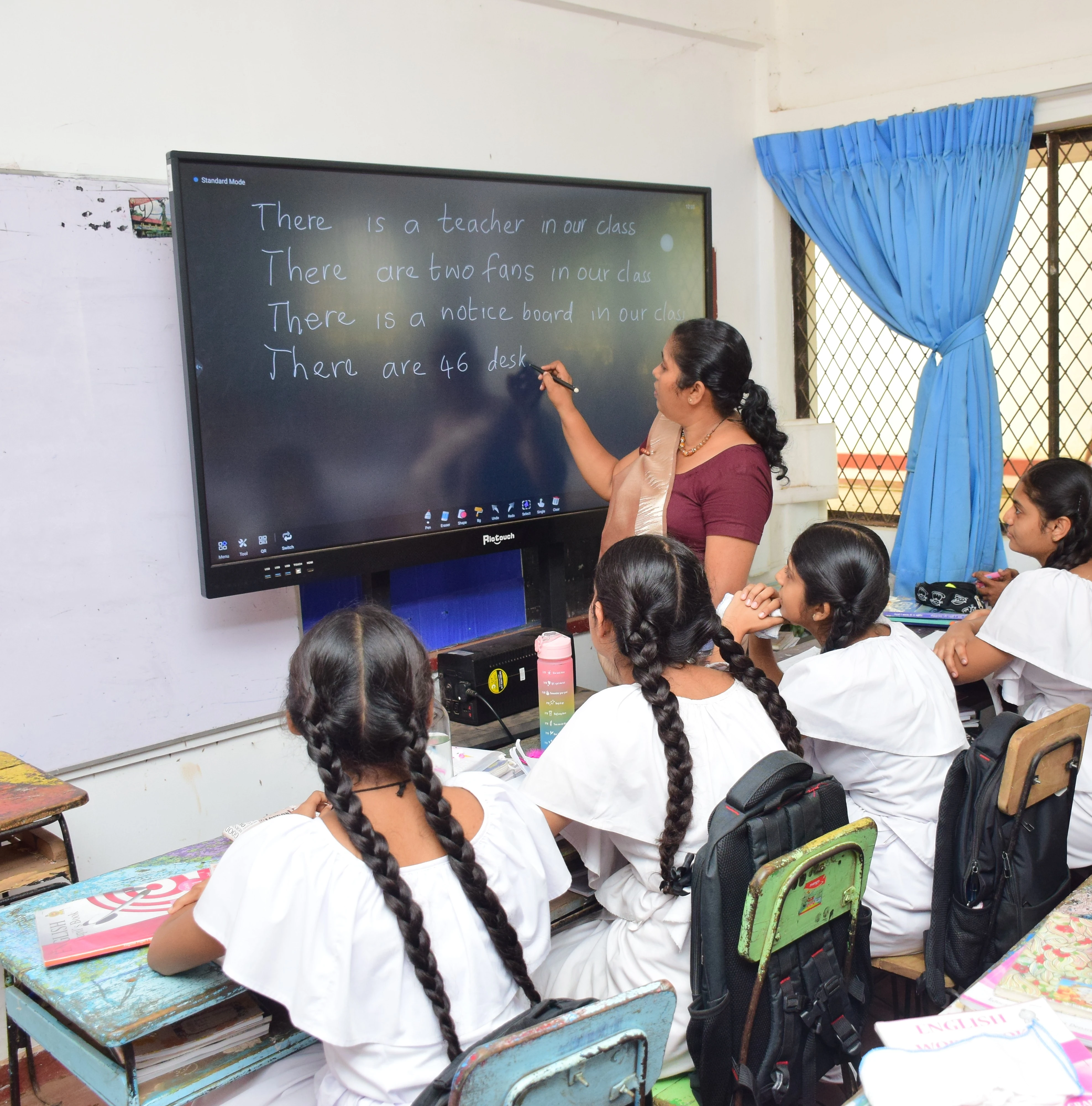 Teacher guiding students at the board